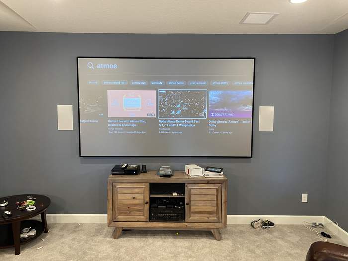 Large mounted TV with surround sound speakers