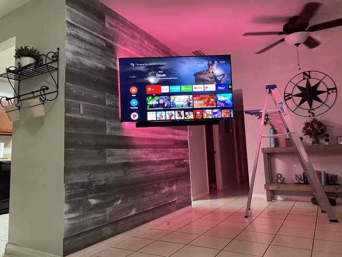 Mounted TV on a weathered wood accent wall